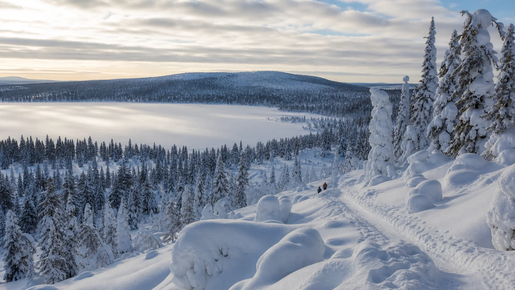Snow-covered fells, forest and frozen lake in Finnish Lapland